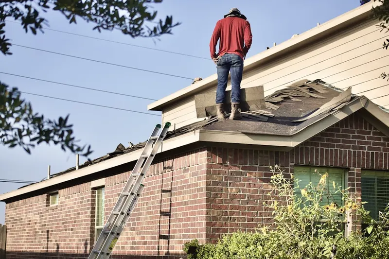 Professional roofer working on a residential roof in Valencia West